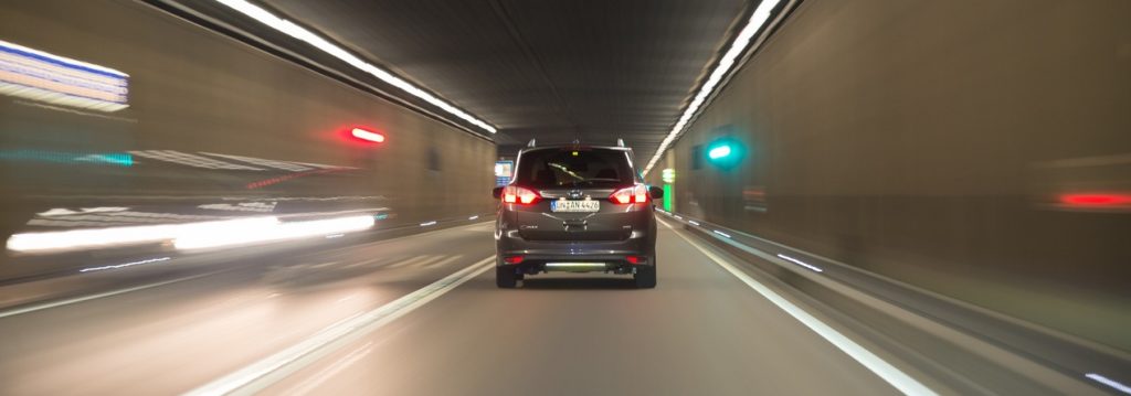 Fast moving car in tunnel at night Connected and Autonomous Vehicles grant funding